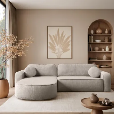 A modern living room with a sectional sofa, artwork, and a bookshelf.