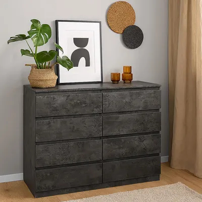 A dresser with drawers in a room setting.