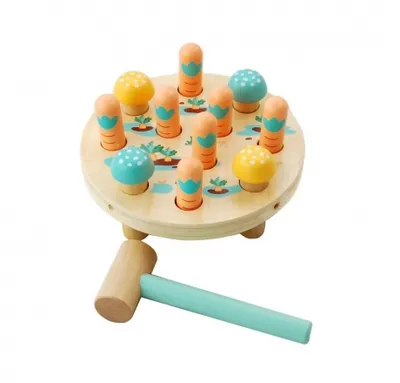 A wooden toy hammer and a wooden pounding toy with carrot and mushroom pegs.