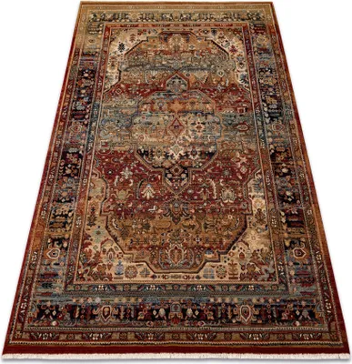 A Persian-style rug with intricate patterns and a fringe.