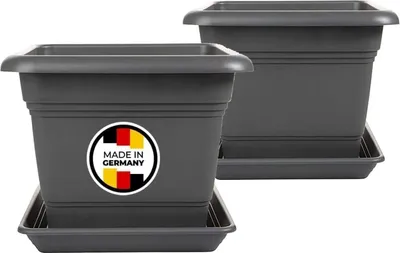 Two dark gray square planters with saucers are shown. The front planter has a circular sticker with the German flag and the text "MADE IN GERMANY".