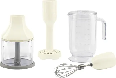 A collection of accessories for a hand blender, including a chopper attachment, a whisk attachment, and a measuring jug, laid out on a white background.