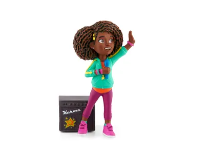 A figurine of a young girl holding a microphone and standing next to a speaker.