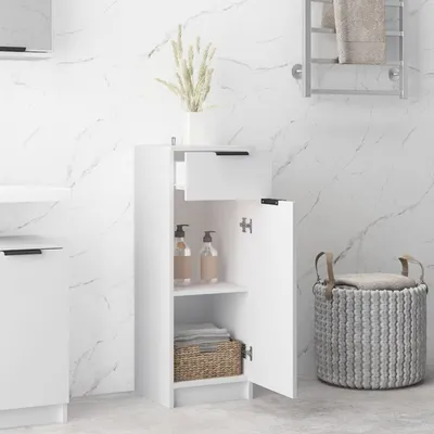 A white bathroom cabinet with an open door, revealing shelves with bottles and towels. A woven basket sits next to it.