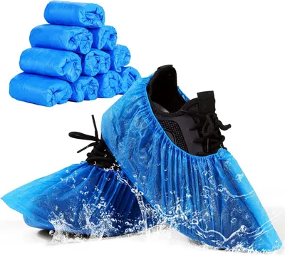 A stack of rolled-up blue shoe covers and a pair of shoes with blue shoe covers on them, with water splashing around the shoes.
