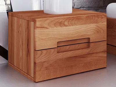 A close-up view of a wooden nightstand with two drawers.