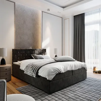 A bedroom scene with a bed as the main focus, styled with bedding and decor.