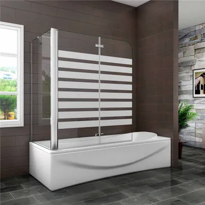 A modern bathroom with a bathtub and a shower screen.