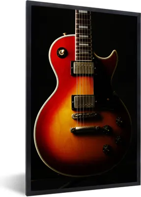 Produktbild von MuchoWow® Gerahmtes Poster Eine rot gefärbte E-Gitarre 40x60 cm - Poster mit Schwarzem Bilderrahmen Wandposter Rahmen Foto Bilder - Papierdruck - Wandbilder