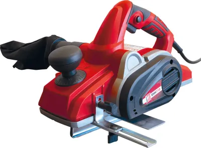 A red and black electric hand planer is shown against a white background.