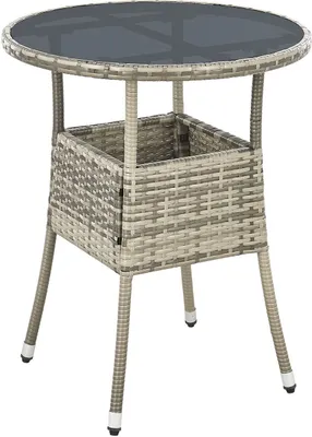 A round outdoor table made of polyrattan with a glass top and a storage compartment.