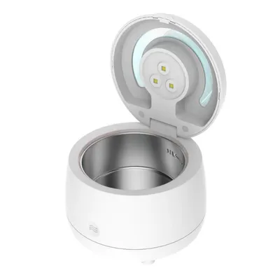 A white ultrasonic cleaner with its lid open, showing the interior and the cleaning mechanism.