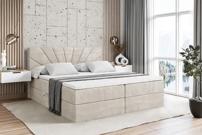 A bedroom scene featuring a large bed with a headboard, bedside tables, and a window with a view.