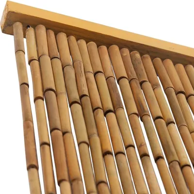A close-up view of a bamboo door curtain hanging from a wooden rod.