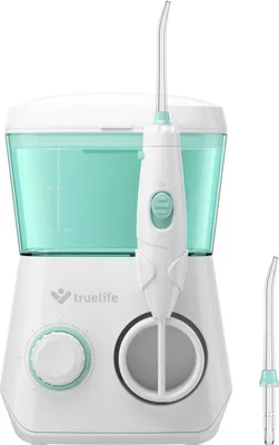 A white and teal water flosser station with its handle and an extra nozzle.