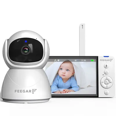 A baby monitor camera and its parent unit are displayed against a white background. The parent unit shows a live feed of a baby.