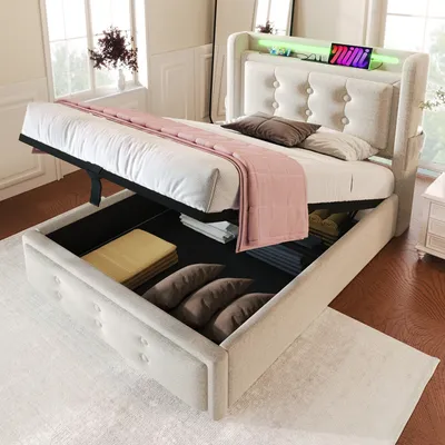 A beige upholstered bed with its storage compartment open, revealing stored items. The bed has a tufted headboard with LED lighting and a small digital display.