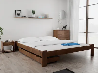 A bedroom scene with a wooden bed.
