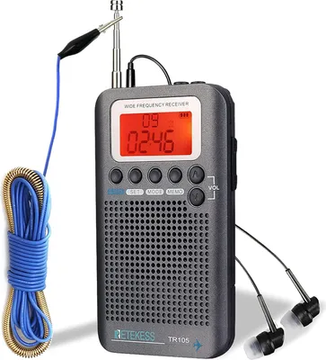 A gray portable radio receiver with a digital display, speaker, and attached accessories like an antenna and earphones, presented against a white background.