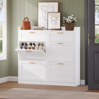 A white shoe cabinet with multiple drawers and flip-down compartments, shown in a room with green walls and a window.