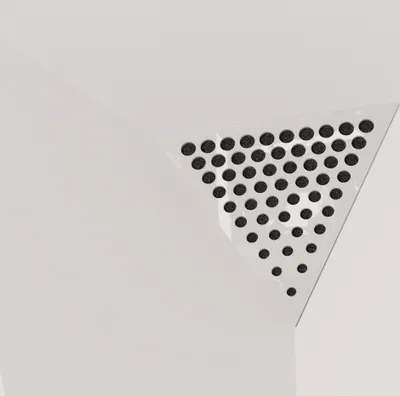 A close-up view of a white triangular acoustic foam panel with a perforated surface, designed for corners.