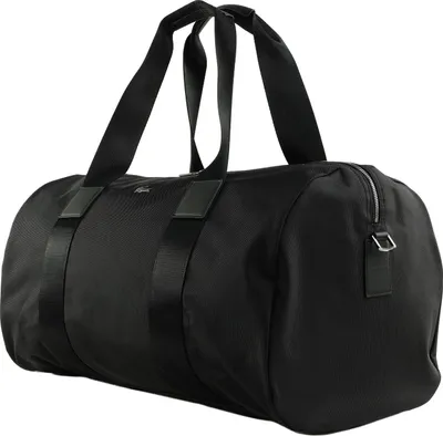 A black duffel bag with black straps and leather accents, shown against a white background.