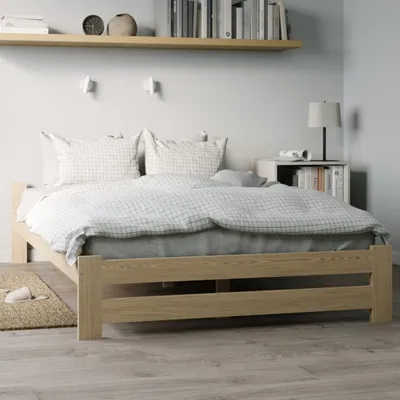 A wooden bed frame with bedding in a bedroom setting.