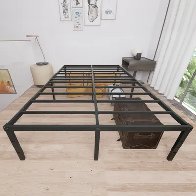 A metal bed frame is shown in a room with light wooden floors, a trunk, and a window with white curtains.