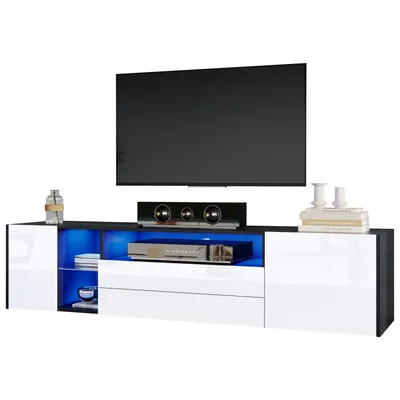 A modern TV stand with a television on top, and electronic equipment on the stand.
