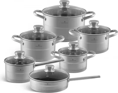 A set of stainless steel pots and pans with glass lids, arranged on a white background.