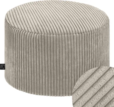 A close-up studio shot of a round, beige corduroy ottoman.