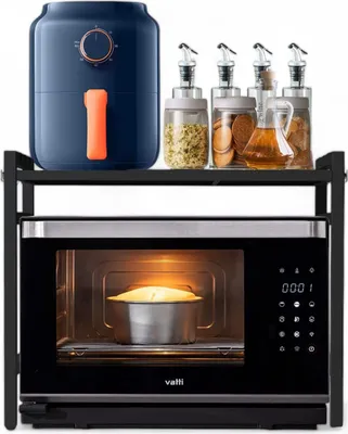 A kitchen shelf unit with a microwave and an air fryer with accessories.