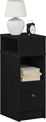 A black nightstand with a drawer and an open shelf, featuring a white lamp and a black alarm clock on top.