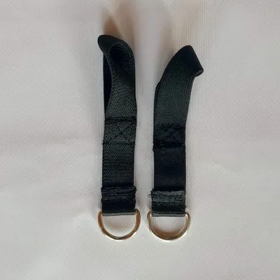 Two black elastic straps with D-rings attached to the ends, laid flat on a white background.