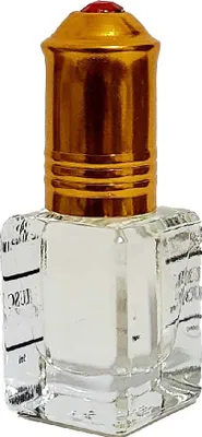 A small, clear glass perfume bottle with a gold cap and a red gem on top.