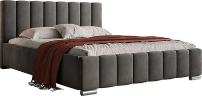 A bed with a headboard and footboard, covered with a brown throw blanket.