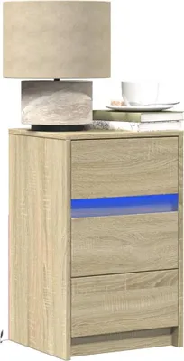 A bedside table with a lamp, books, and a cup of coffee.