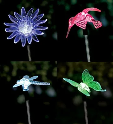 A collage of four different solar-powered garden lights in the shape of a flower, a hummingbird, a dragonfly, and a butterfly, displayed against a dark background.