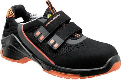 A studio shot of a black safety shoe with orange accents.