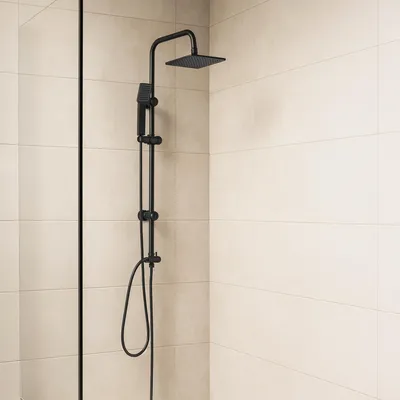 A black shower system mounted on a tiled wall.