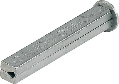A silver-colored metal object with text embossed on it, lying on a white background.