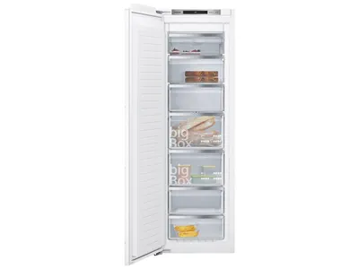 An open white freezer with multiple transparent drawers, some containing food items.