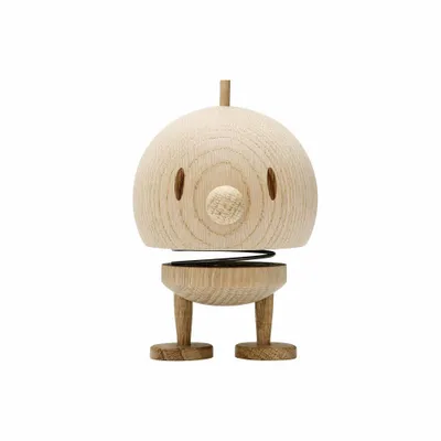 A wooden toy figure with a round head and two legs, standing on a white background.