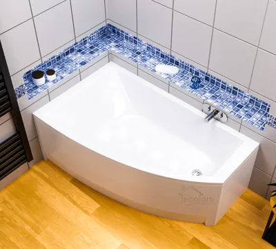 A modern bathroom corner bathtub with blue mosaic tile accents.
