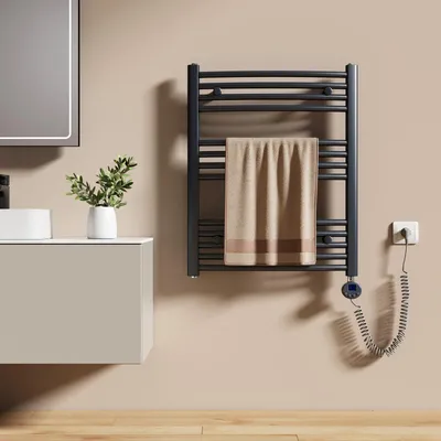 A bathroom scene with a sink, vanity, and a heated towel rack.