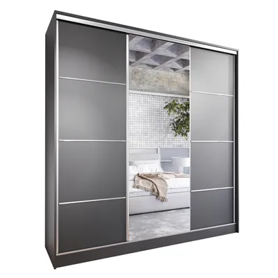 A sliding door wardrobe with mirrored panels, reflecting a bedroom interior.