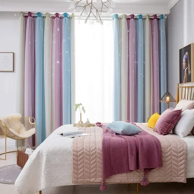 A bedroom scene with a bed, curtains, and a chair.