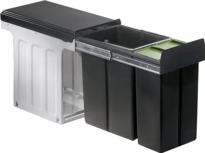 A pull-out waste bin system with two black bins and a green lid insert, mounted on a sliding mechanism.