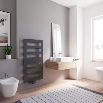 A modern bathroom with a matte black radiator, a bidet, a floating vanity with a sink, and a large window.