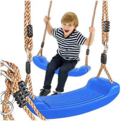 A young boy is happily sitting on a blue swing set, which is suspended by brown ropes. The swing set appears to be designed for outdoor or indoor use.
